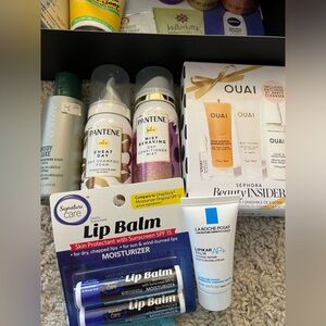 Travel items bundle includes brands Ouai Pantene and FirstAid Beauty